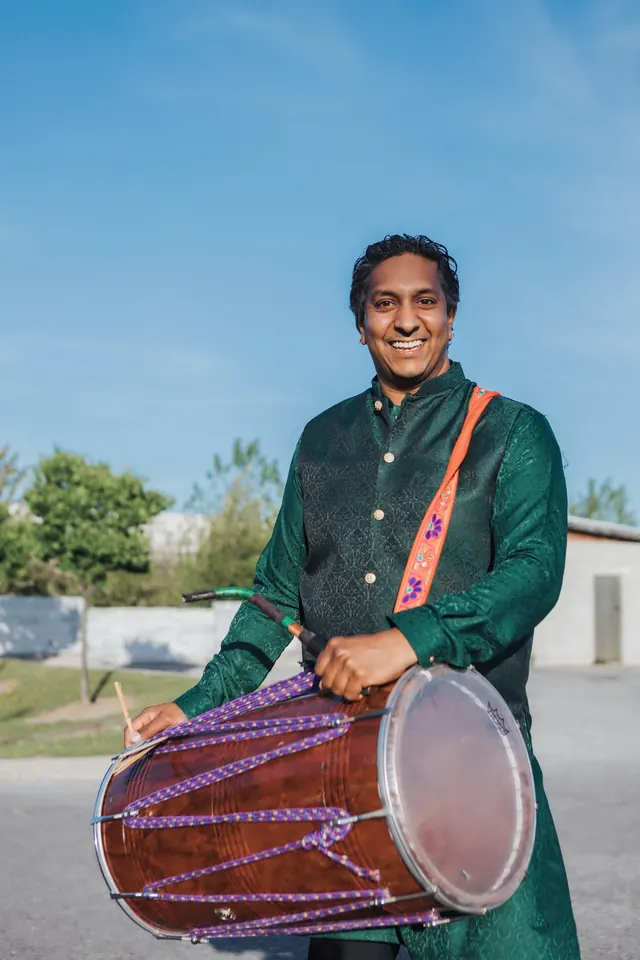 Playing the dhol.