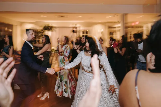Taking the bride’s hand.
