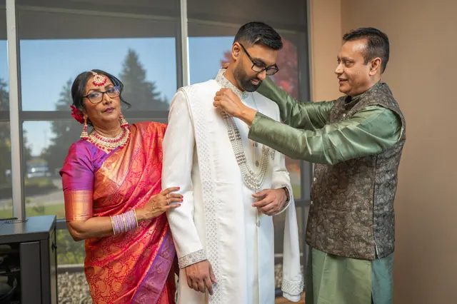 Being dressed by the family.